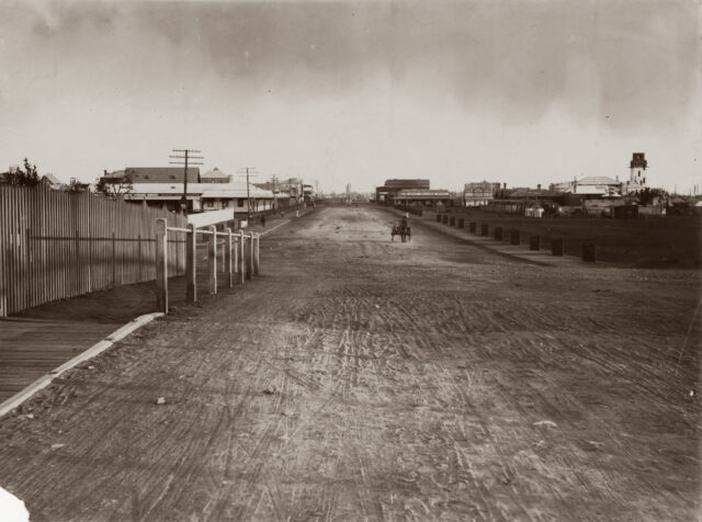 A long stretch of road with buildings on either side.