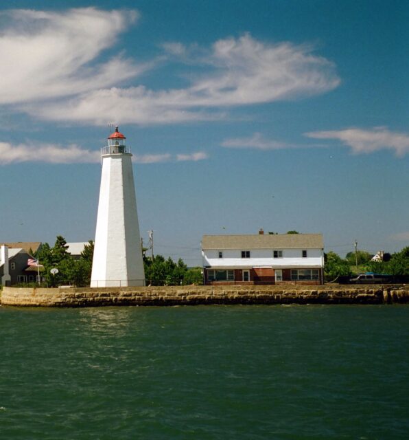 A lighthouse and home on the edge of a body of water