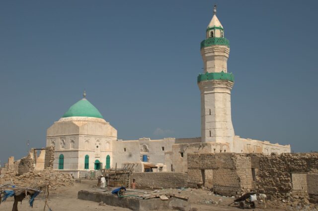 A mosque with green accents