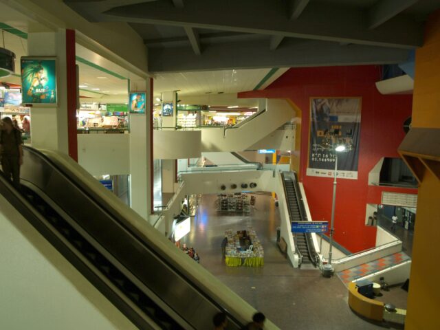 Different floors and escalators inside a bus station.