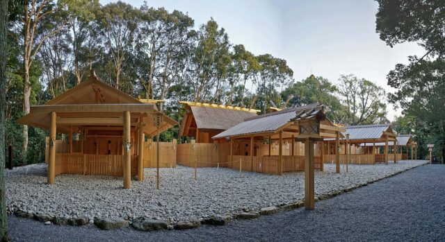 Several wooden shrine buildings lining a stone path.