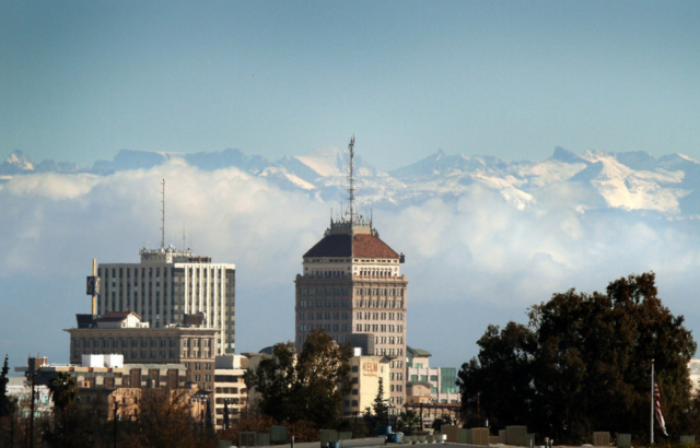 Downtown Fresno, Calif., skyline can be seen below snow caps the Sierra Nevada mountains and clouds along the foothills, Dec. 14, 2009.