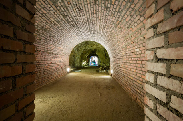 Underground bunker constructed of red brick with curved walls.