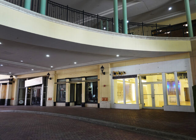 A string of abandoned storefronts in a mall.