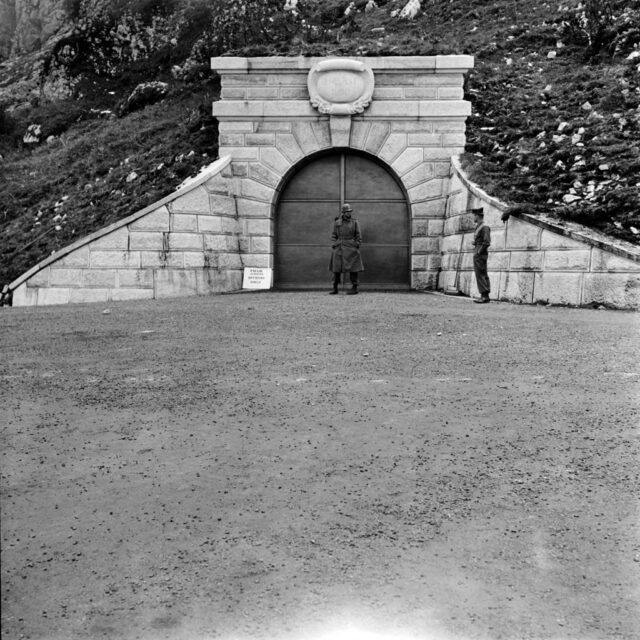 Two US soldiers standing at the elegant stone entrance of the Kehlsteinhaus tunnel.