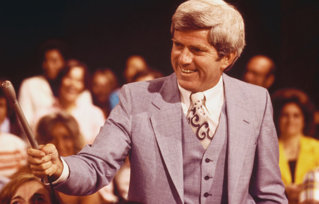 Phil Donahue holding a microphone
