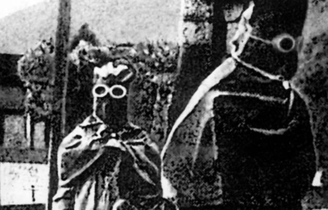 Two members of Unit 731 dressed in protective gear