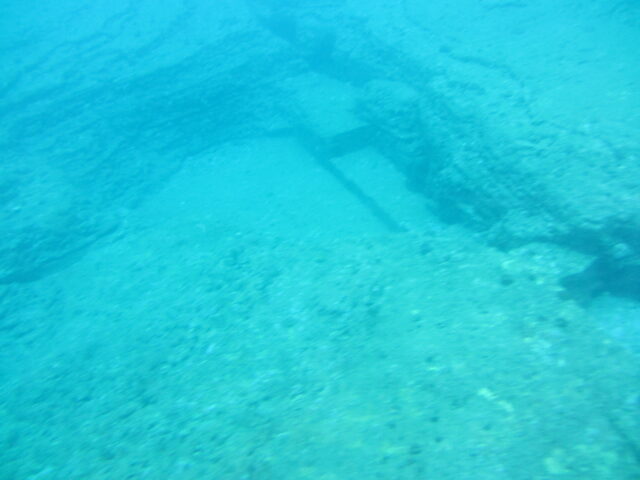 An aerial view of an underwater rock formation with multiple levels.