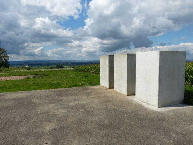 Three concrete blocks sitting on a massive concrete slab.