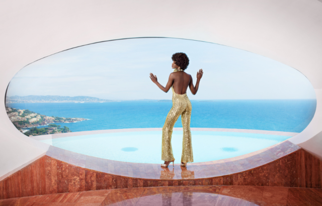 A model poses in the living room window looking out over the Mediterranean, May 20, 2014. 