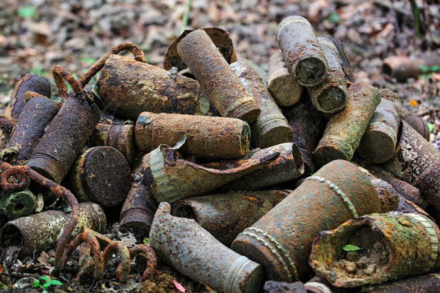 Pile of World War I-era artillery shells on the forest floor