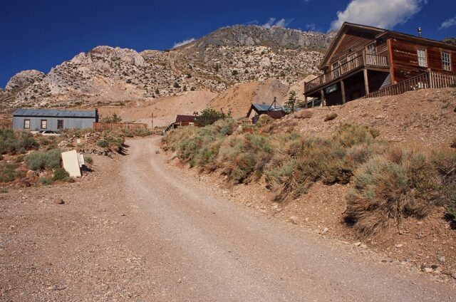 A road leading to several wood buildings.