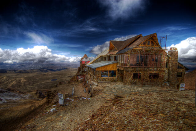 An abandoned ski resort on a snow-less mountain.