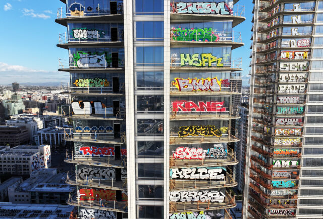Graffiti on windows of a skyscraper.