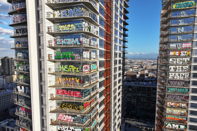 Graffiti on windows of a skyscraper.