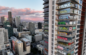 A view of building in LA, a skyscraper with graffiti on its windows.