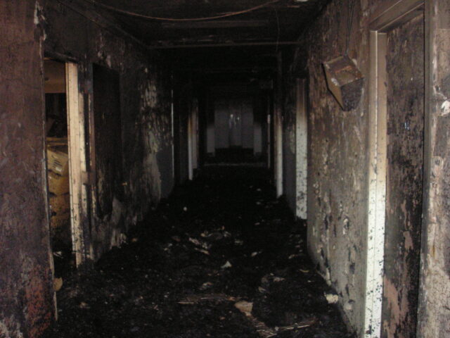 A dark and dilapidated hallway.