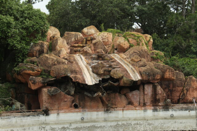 Abandoned waterslides carved into a rocky structure at Disney's River Country