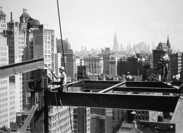 Construction workers on bearings of a skyscraper.