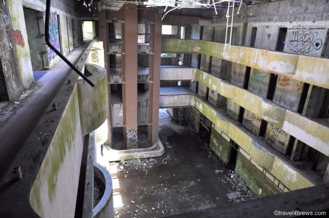 Looking into an abandoned concrete courtyard of Hotel Monte Palace.