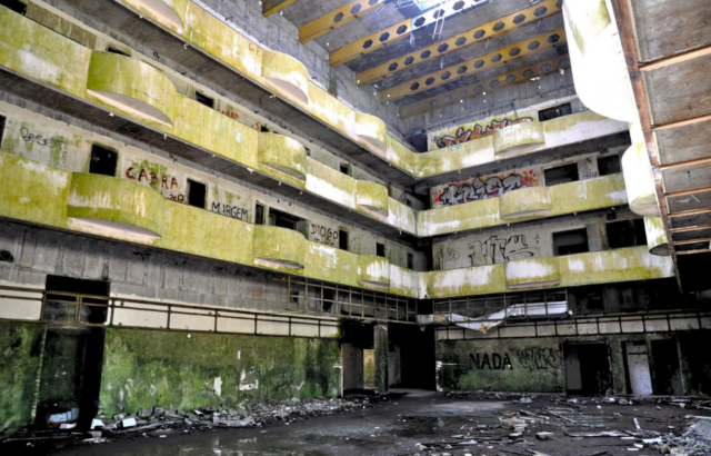 An abandoned concrete courtyard of a hotel.